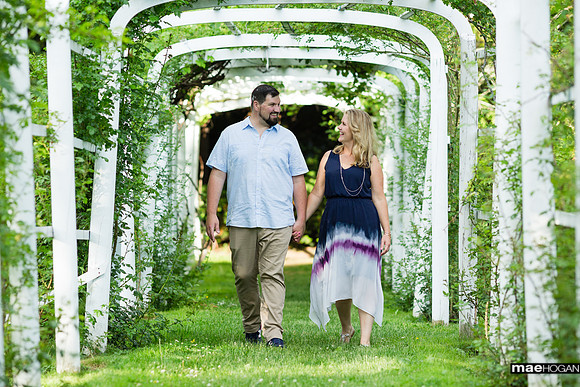Engagement photo walk through the backyard arbor at the Governor John Langdon House