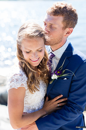 Bride and groom sharing a moment on the rocks on Peaks Island